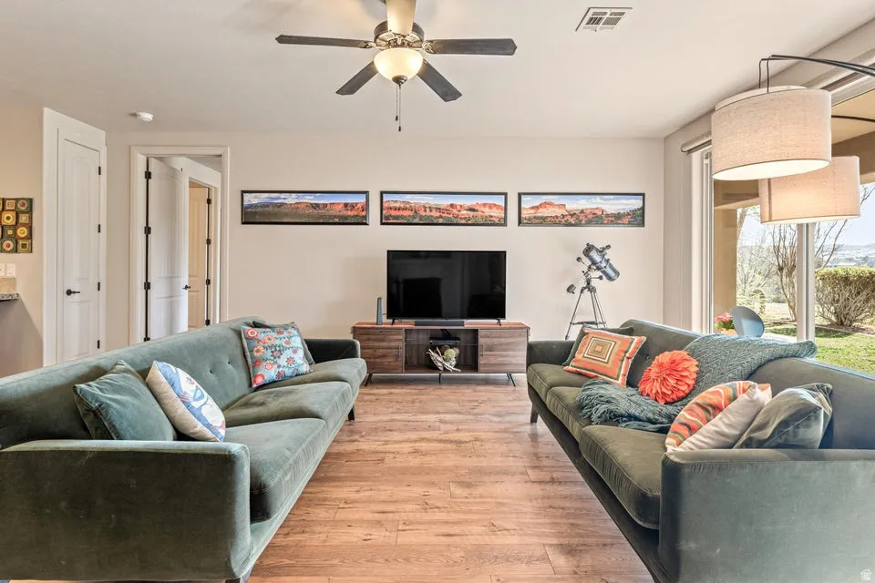 Living area featuring light wood-style flooring and a ceiling fan
