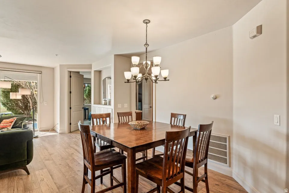 Dining space featuring light wood-type flooring and suspended lighting