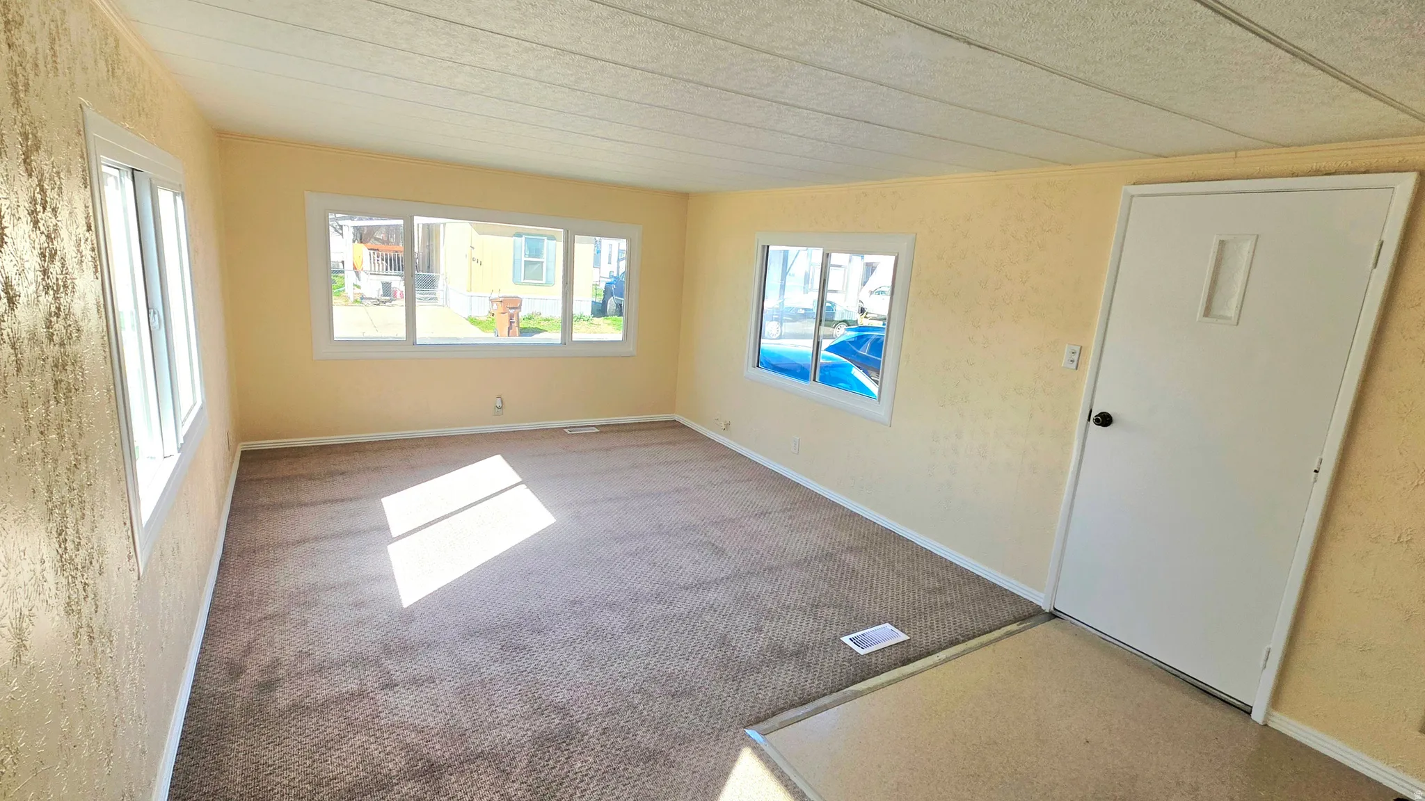 Empty room featuring light carpet