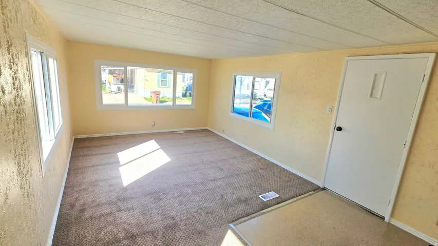 Empty room featuring light carpet
