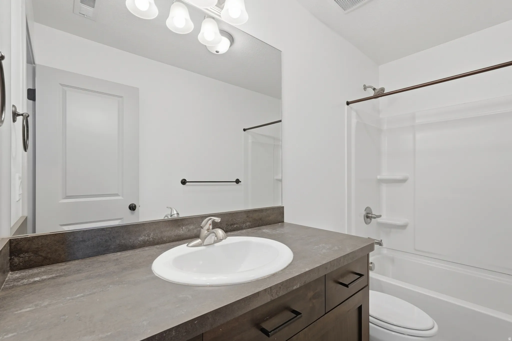 Bathroom featuring vanity and shower / tub combination