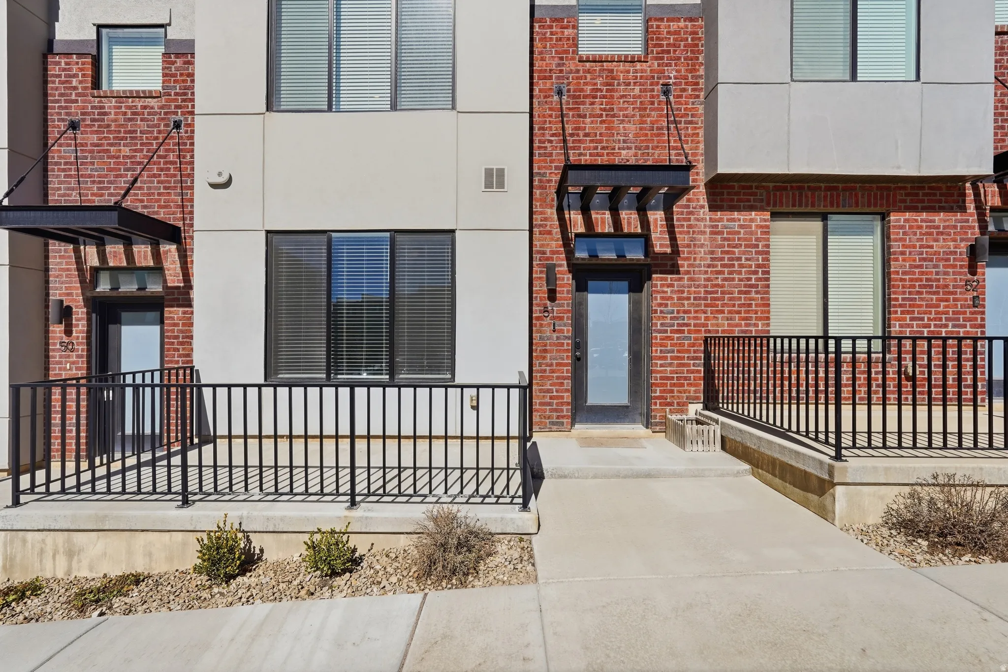 View of exterior entry with brick siding and stucco siding