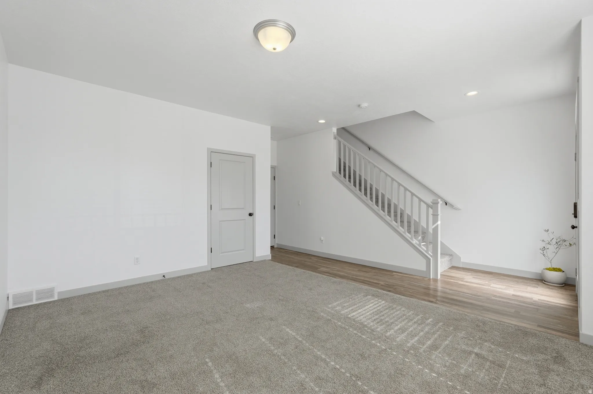 Entryway featuring stairway and light carpet