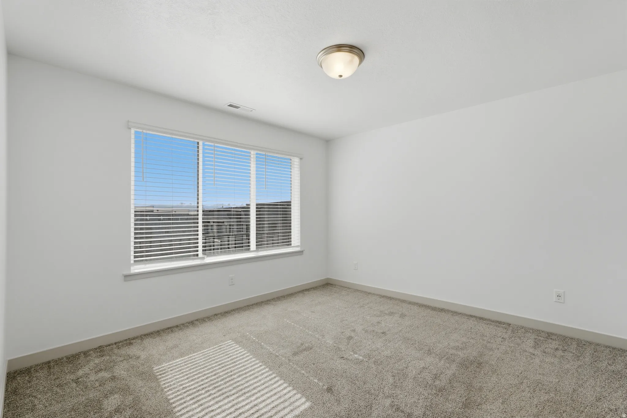 Bedroom with light colored carpet