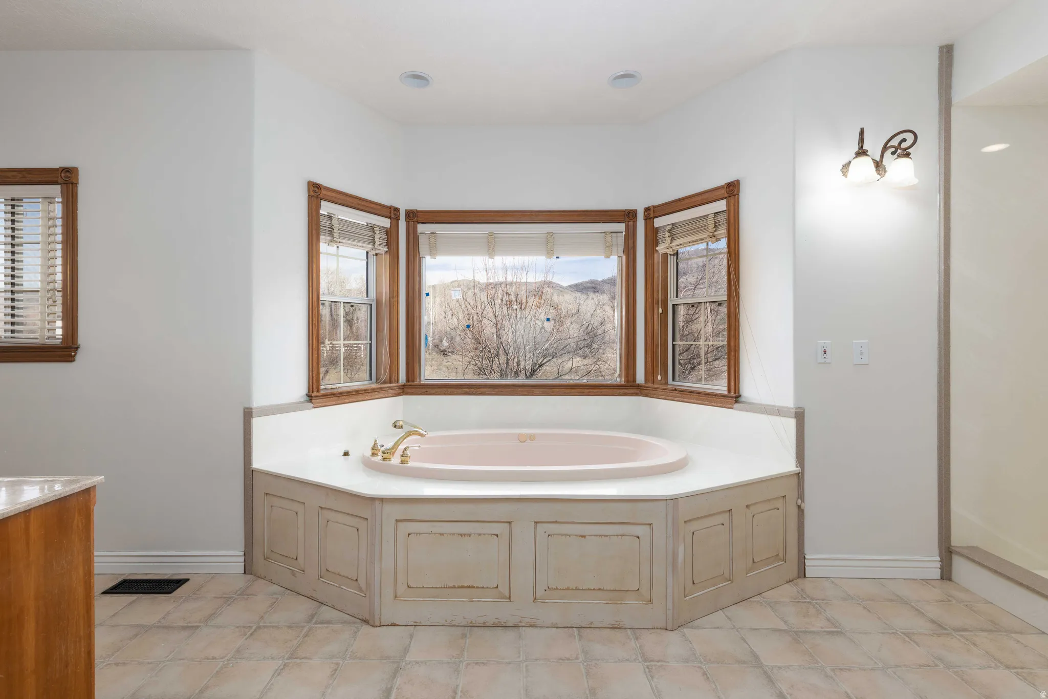 Primary Bathroom with a bath and vanity