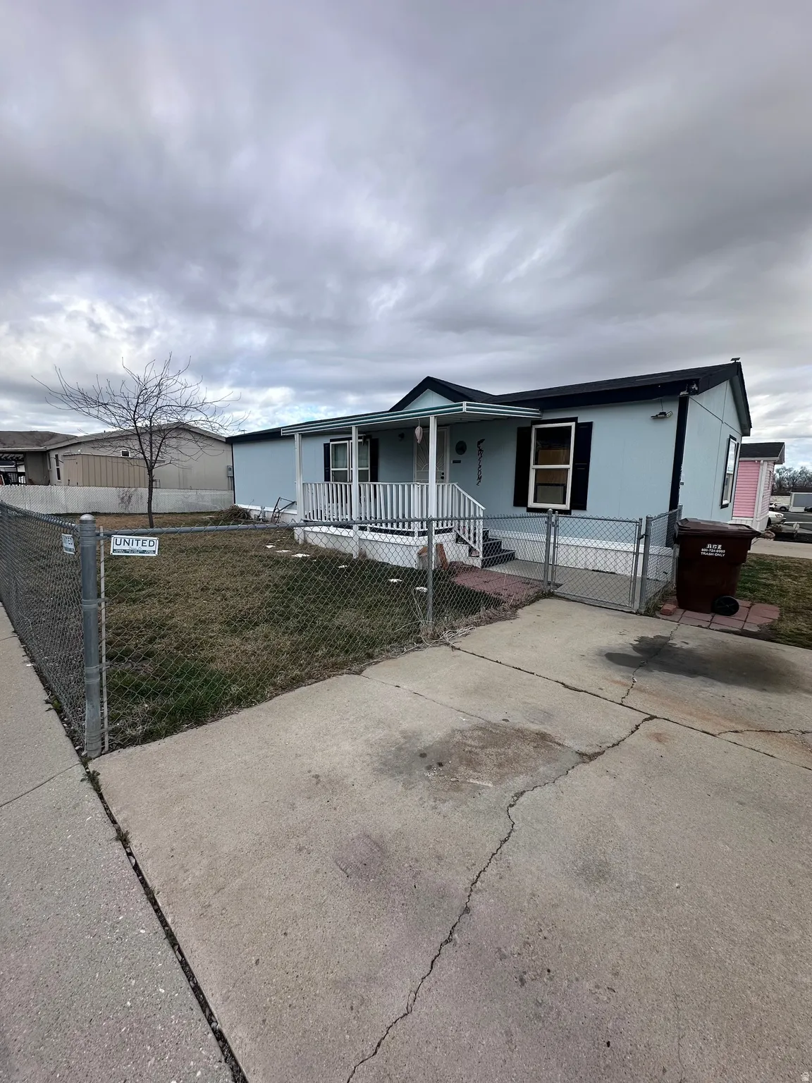 View of front of house featuring a gate, covered porch, and a fenced front yard
