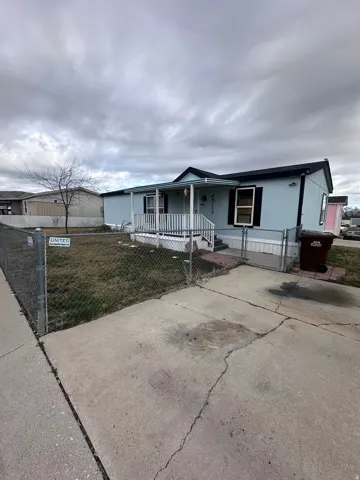 View of front of house featuring a gate, covered porch, and a fenced front yard