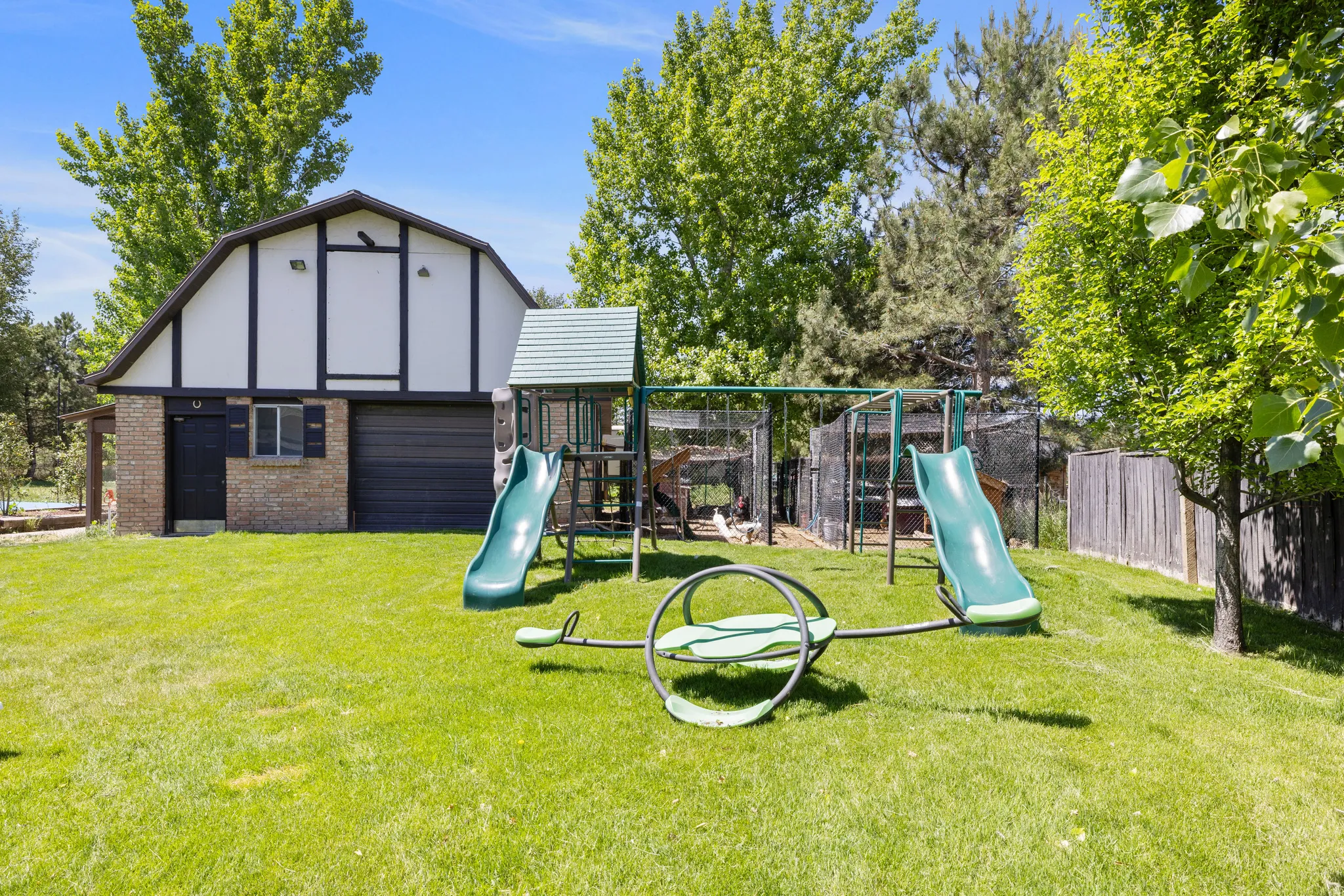 View of jungle gym featuring an outbuilding