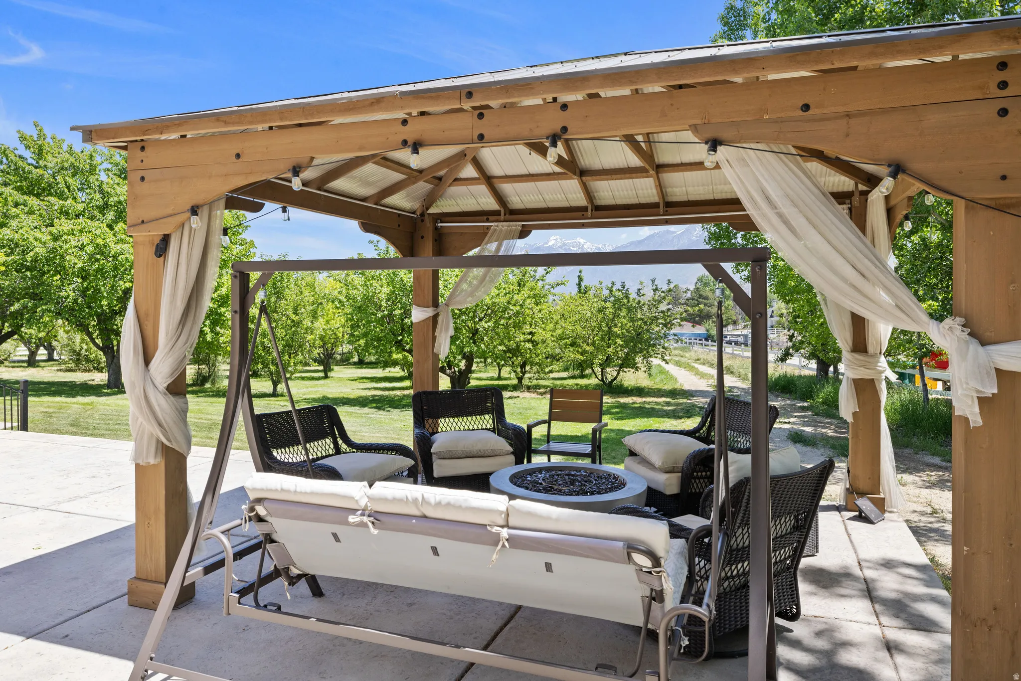 View of patio / terrace featuring an outdoor living space with a fire pit and a gazebo
