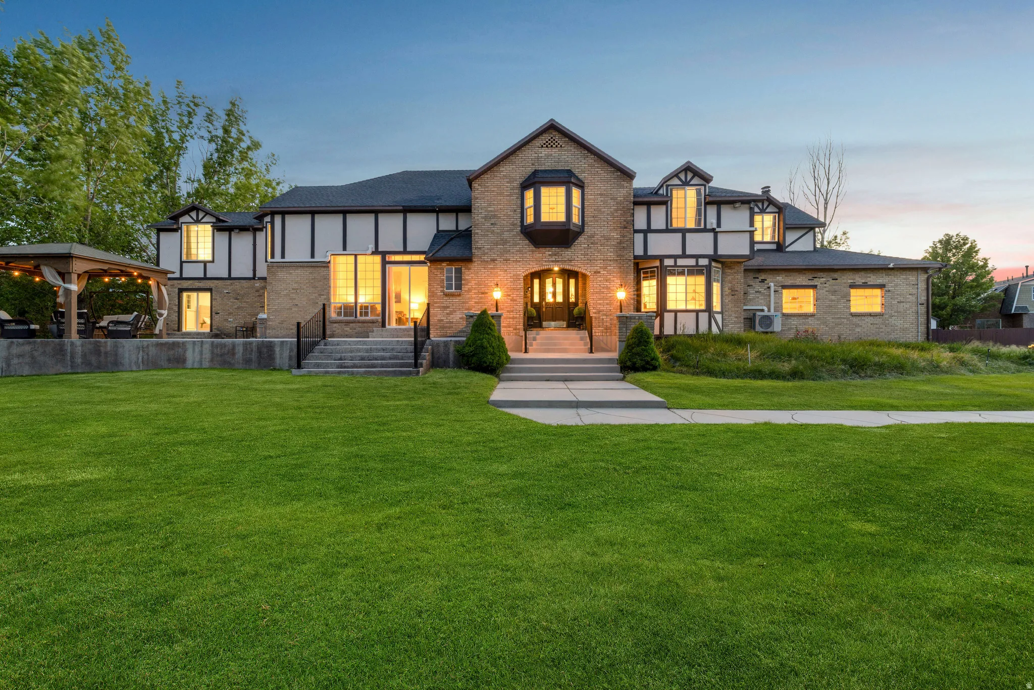 Tudor house with a lawn and brick siding
