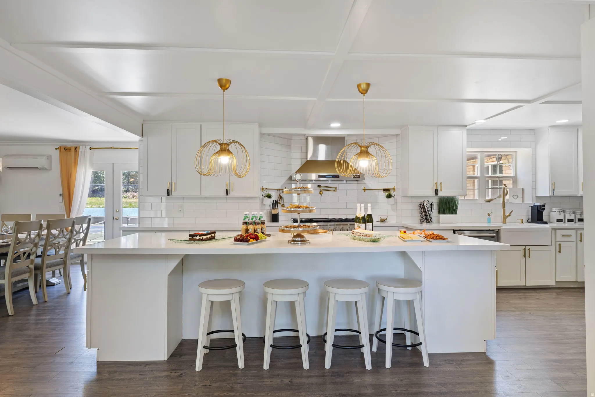 Kitchen with a kitchen bar, a kitchen island, white cabinets, and dark wood-style floors