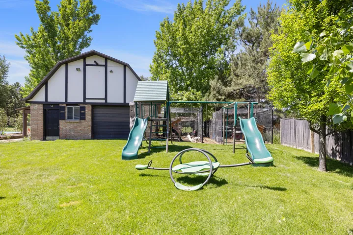 View of jungle gym featuring an outbuilding
