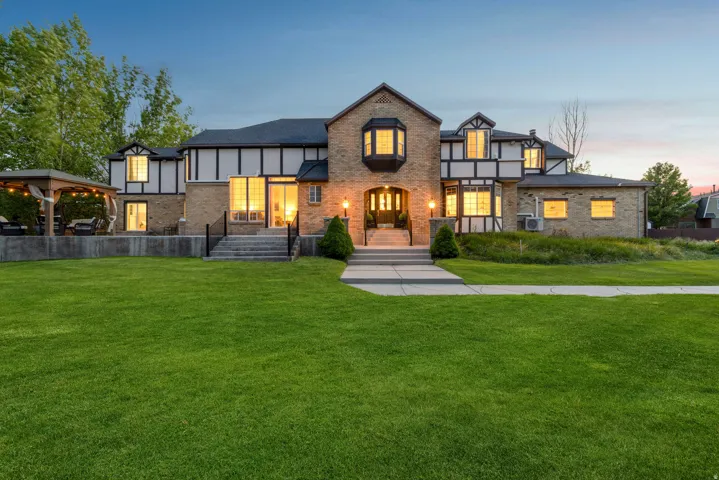 Tudor house with a lawn and brick siding