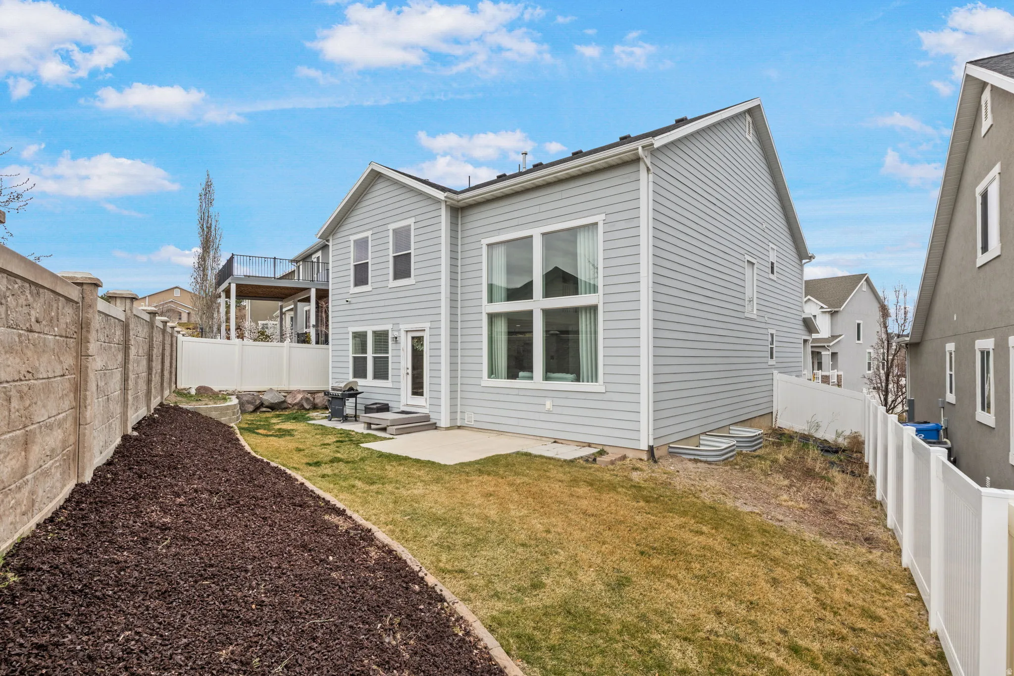 Back of house with a patio area and a fenced backyard