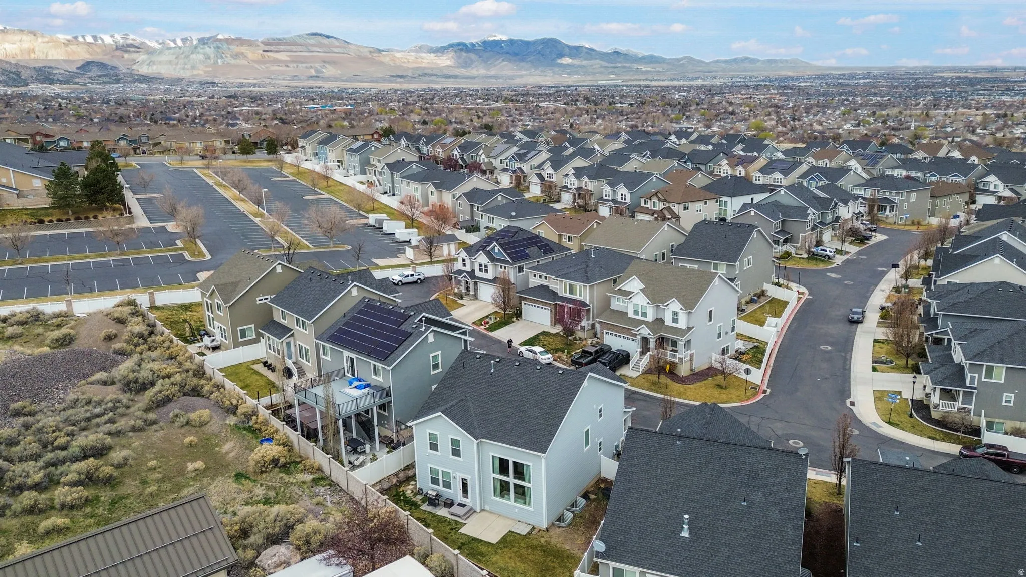 Aerial perspective of suburban area featuring a mountainous background