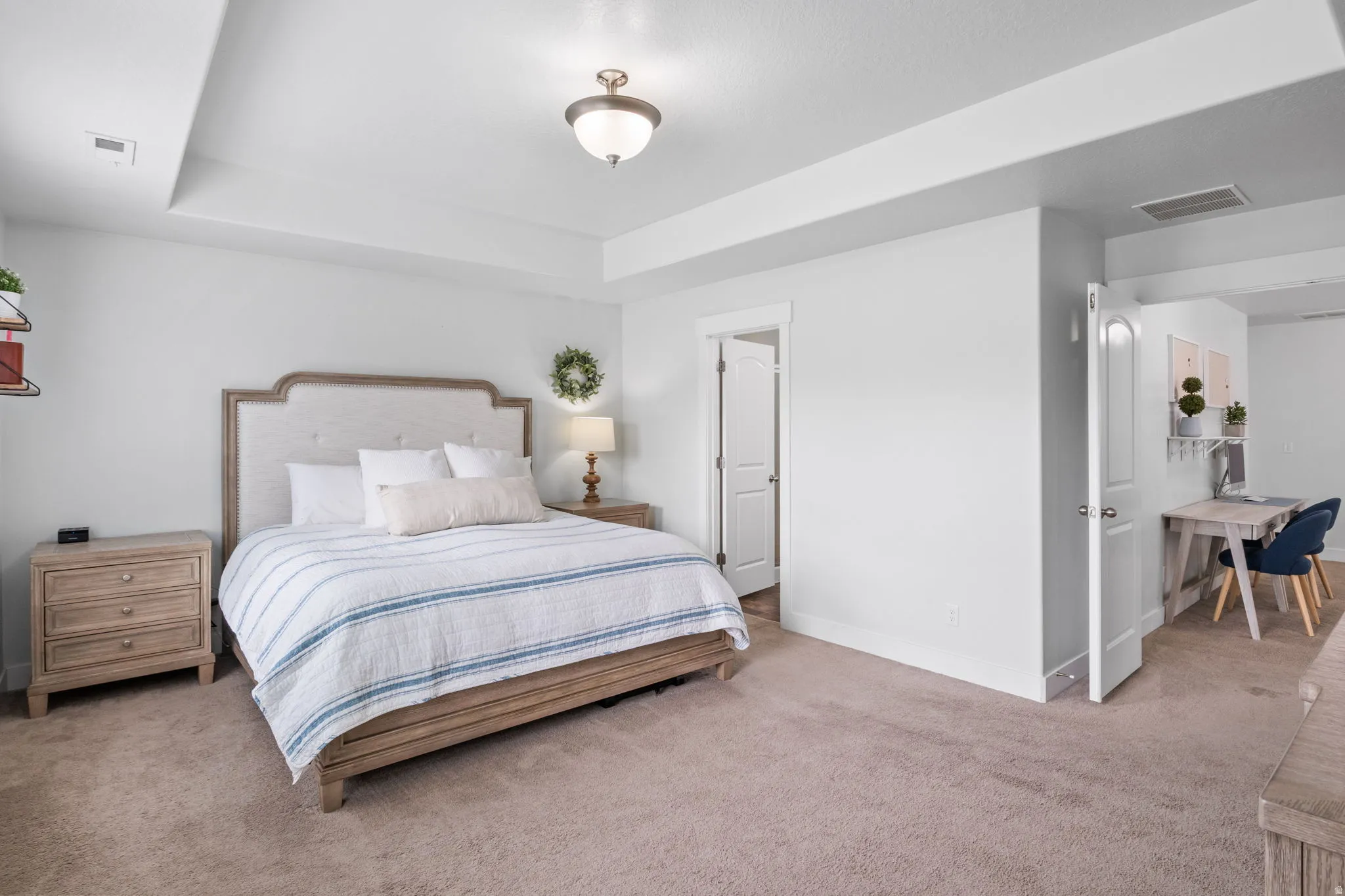 Primary bedroom with a tray ceiling