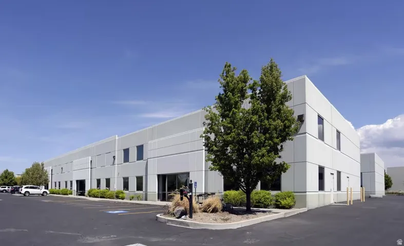 View of building exterior with uncovered parking