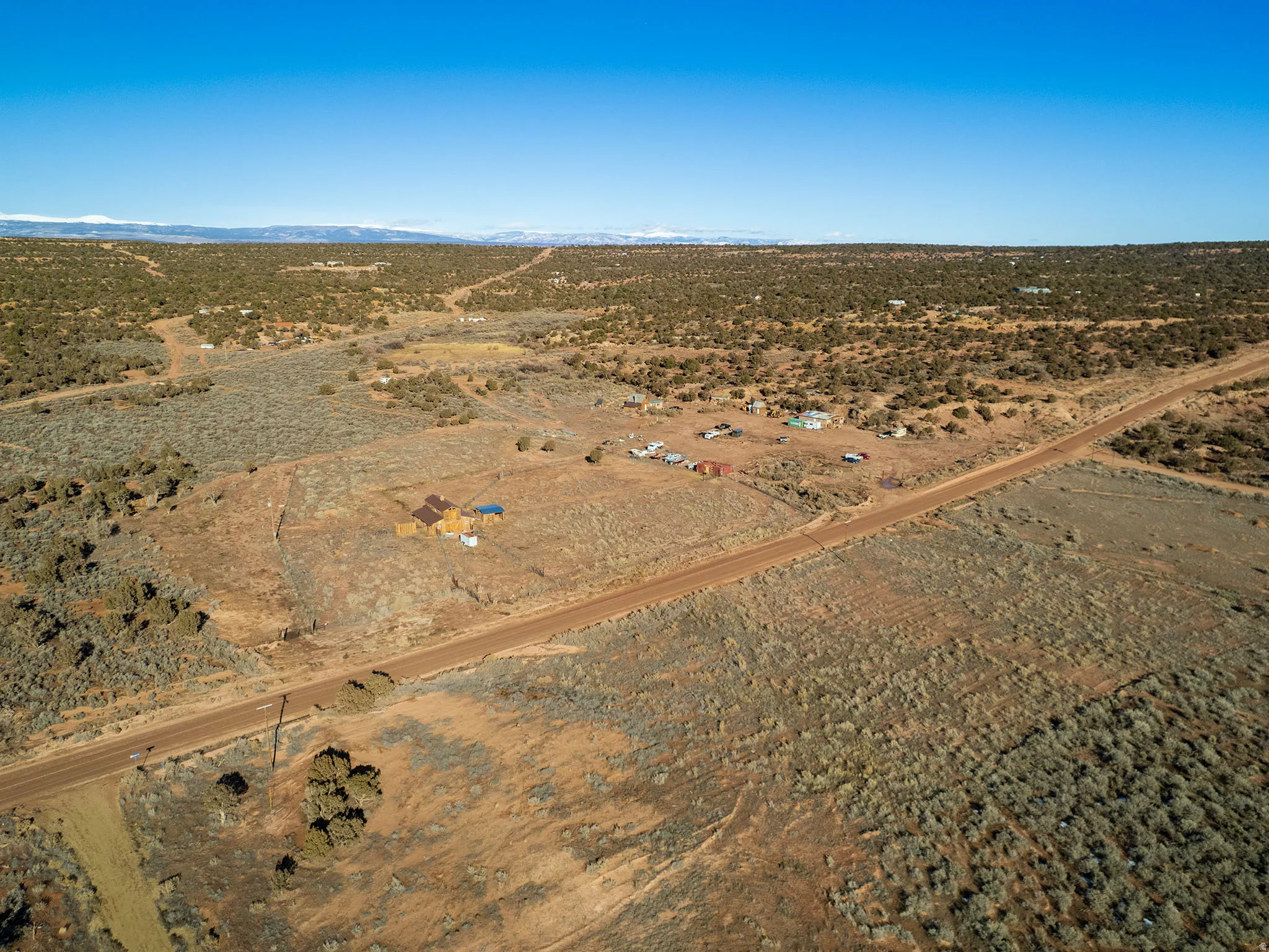 Aerial overview of property's location with rural landscape and mountains