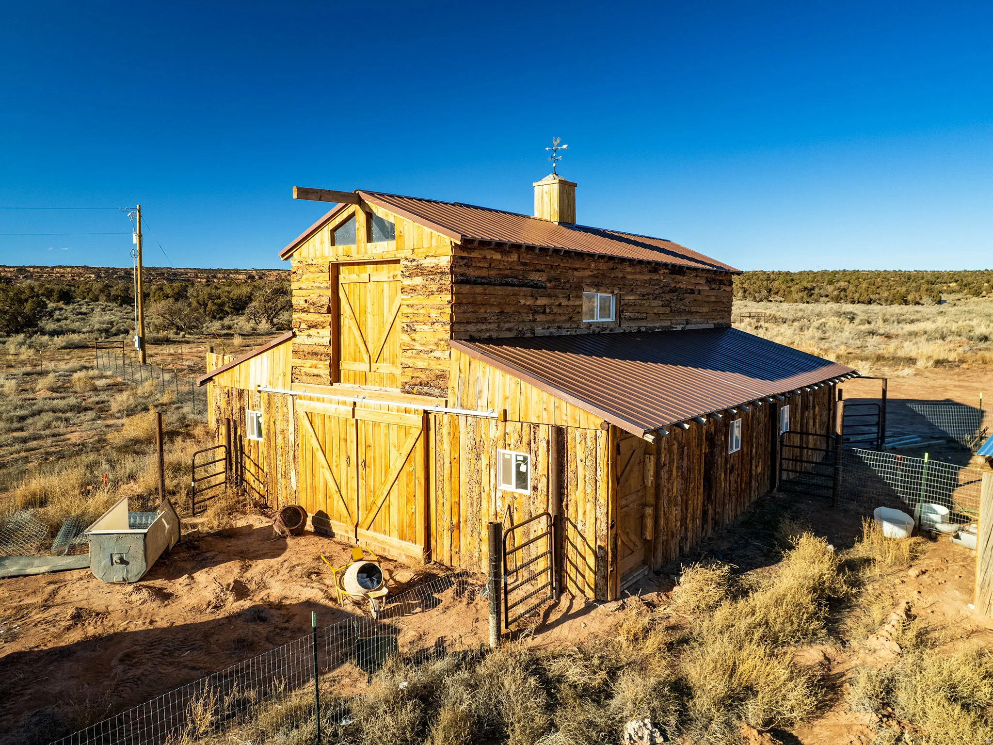 View of barn featuring a rural view, an exterior structure, and a desert view