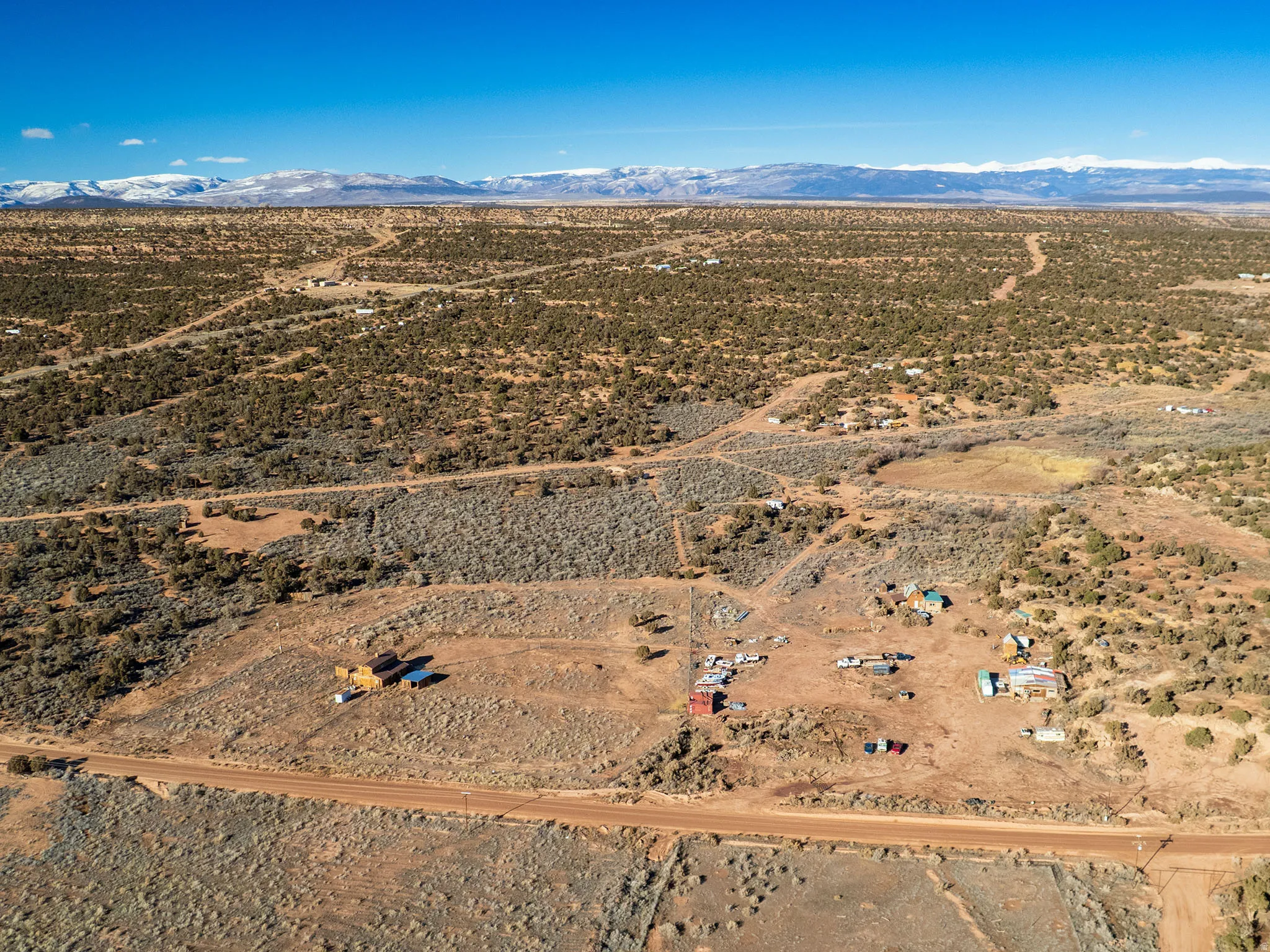 Aerial view of sparsely populated area with a mountainous background