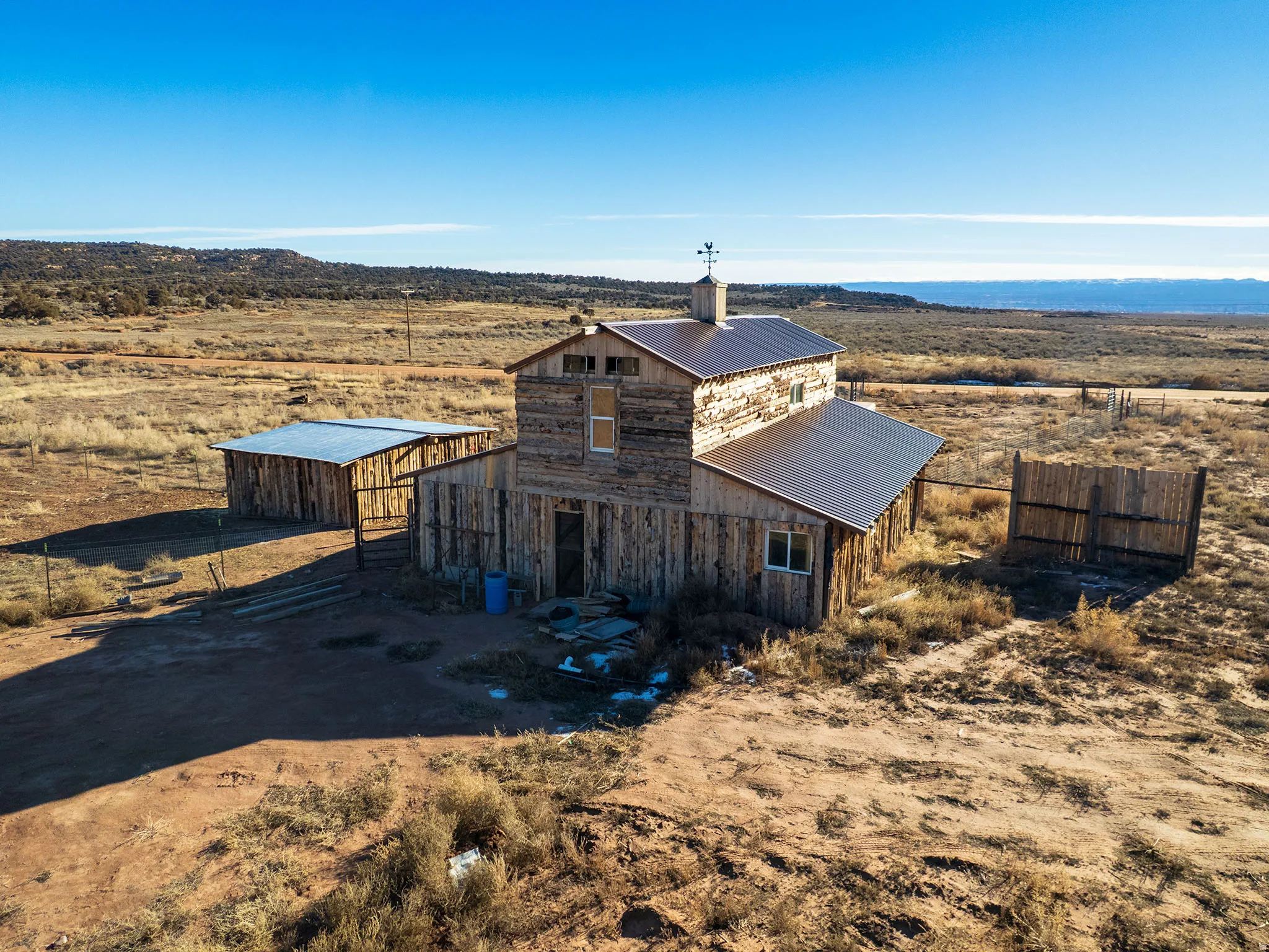 View of front facade featuring a metal roof, an outbuilding, a rural view, and a barn