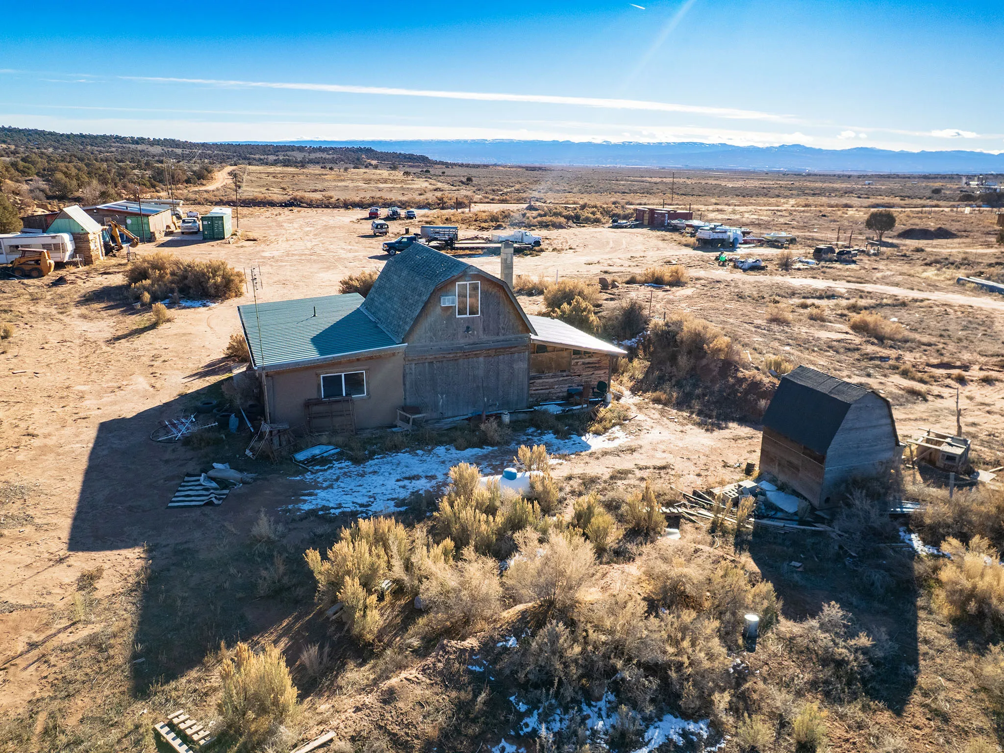 Overview of rural landscape featuring a desert landscape and a mountain backdrop
