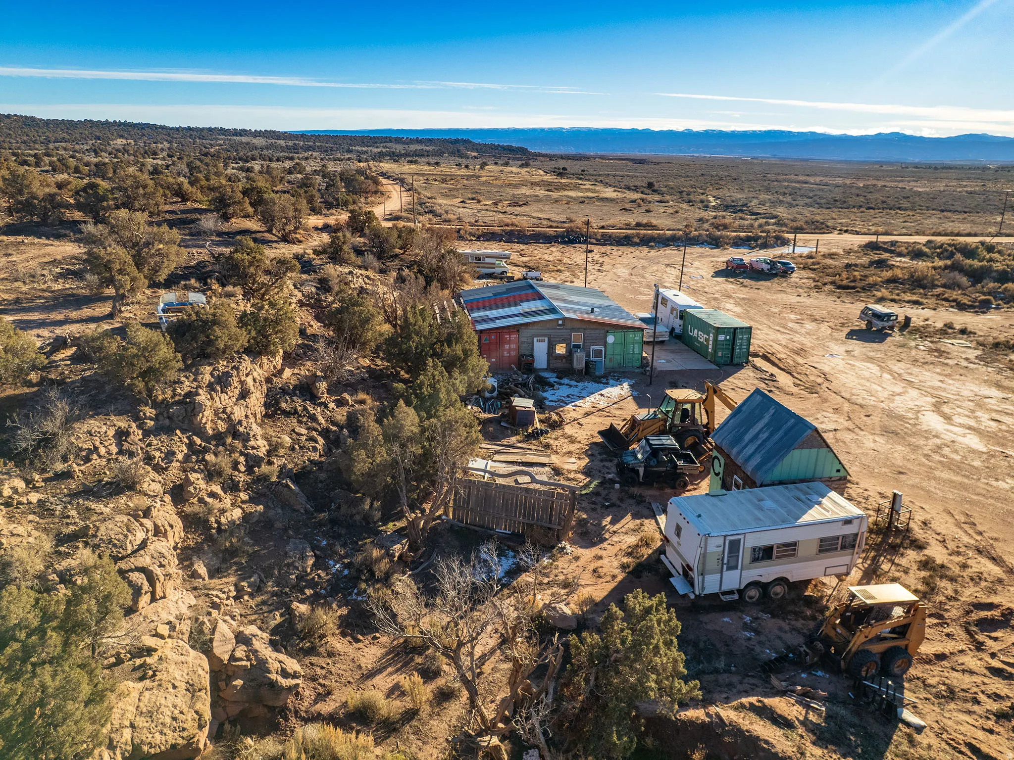 View of rural area with a desert landscape and a mountainous background