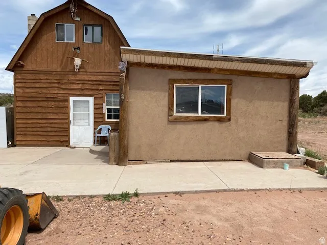 Back of property with a chimney
