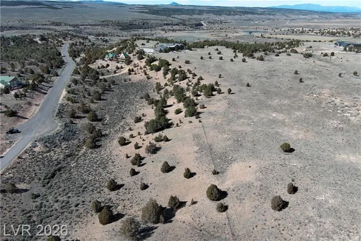 Aerial view of sparsely populated area with a desert landscape and a mountainous background