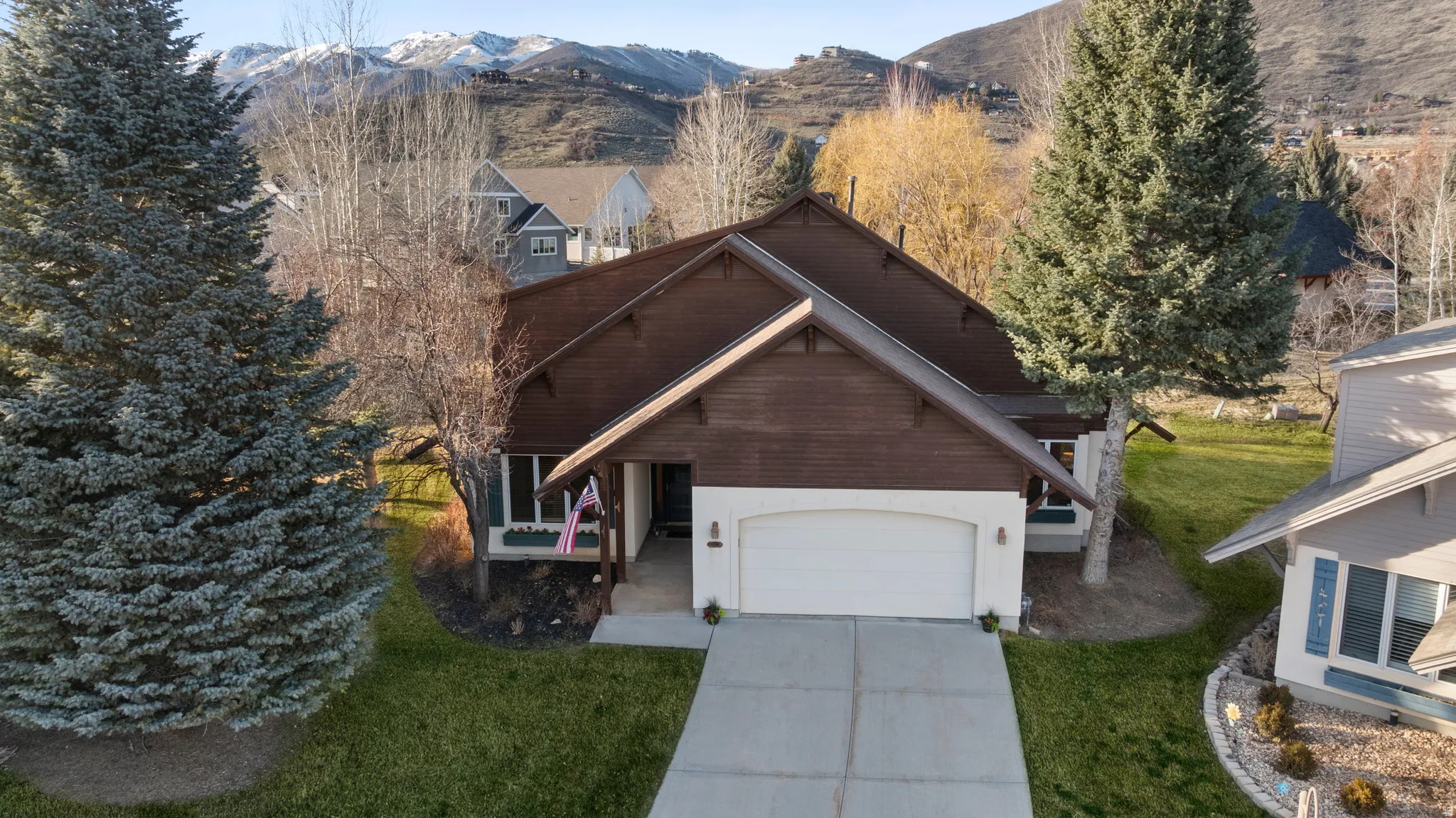 Mature trees bookend the home, offering a sense of privacy.