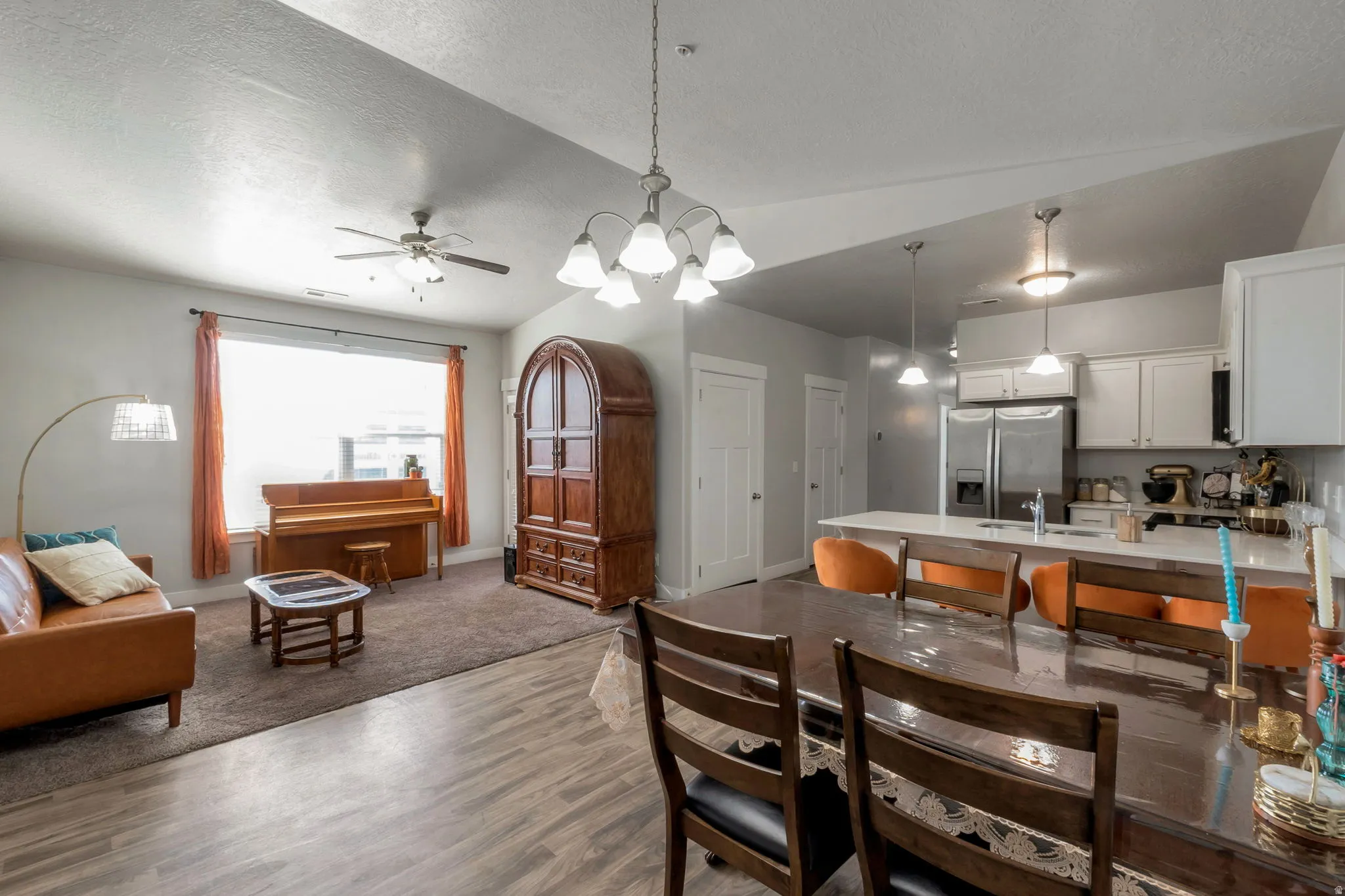 Dining room featuring a chandelier, wood finished floors, and ceiling fan