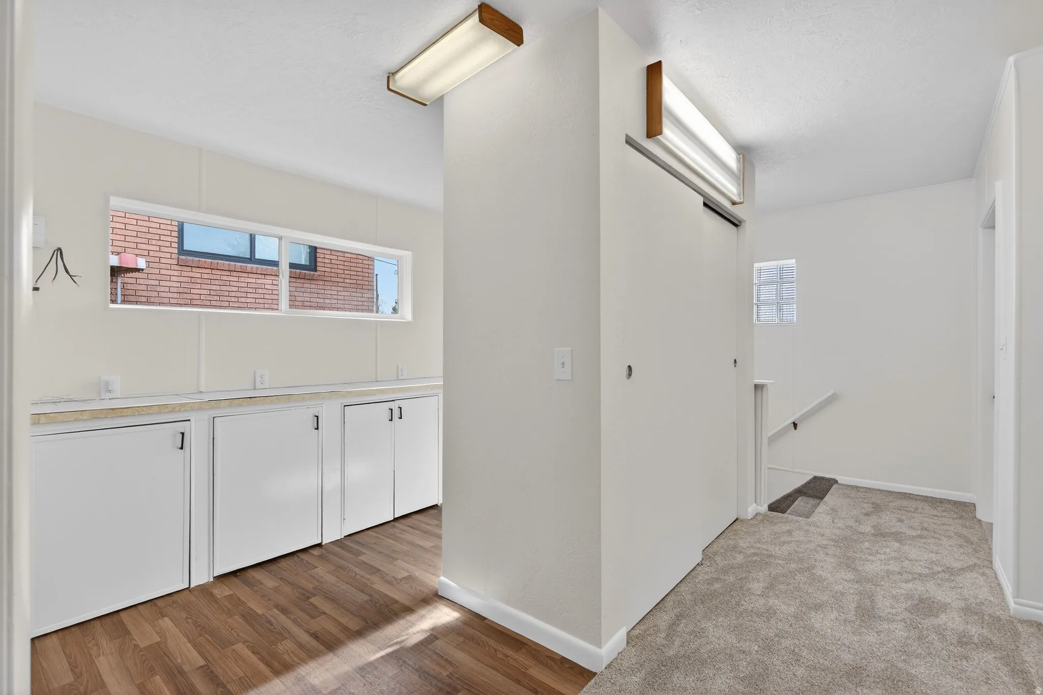 Versatile flex area featuring integrated storage and ample counter space. Bathed in natural light, this multi-purpose nook off the kitchen is perfect for hobbies, organization, or additional prep space.