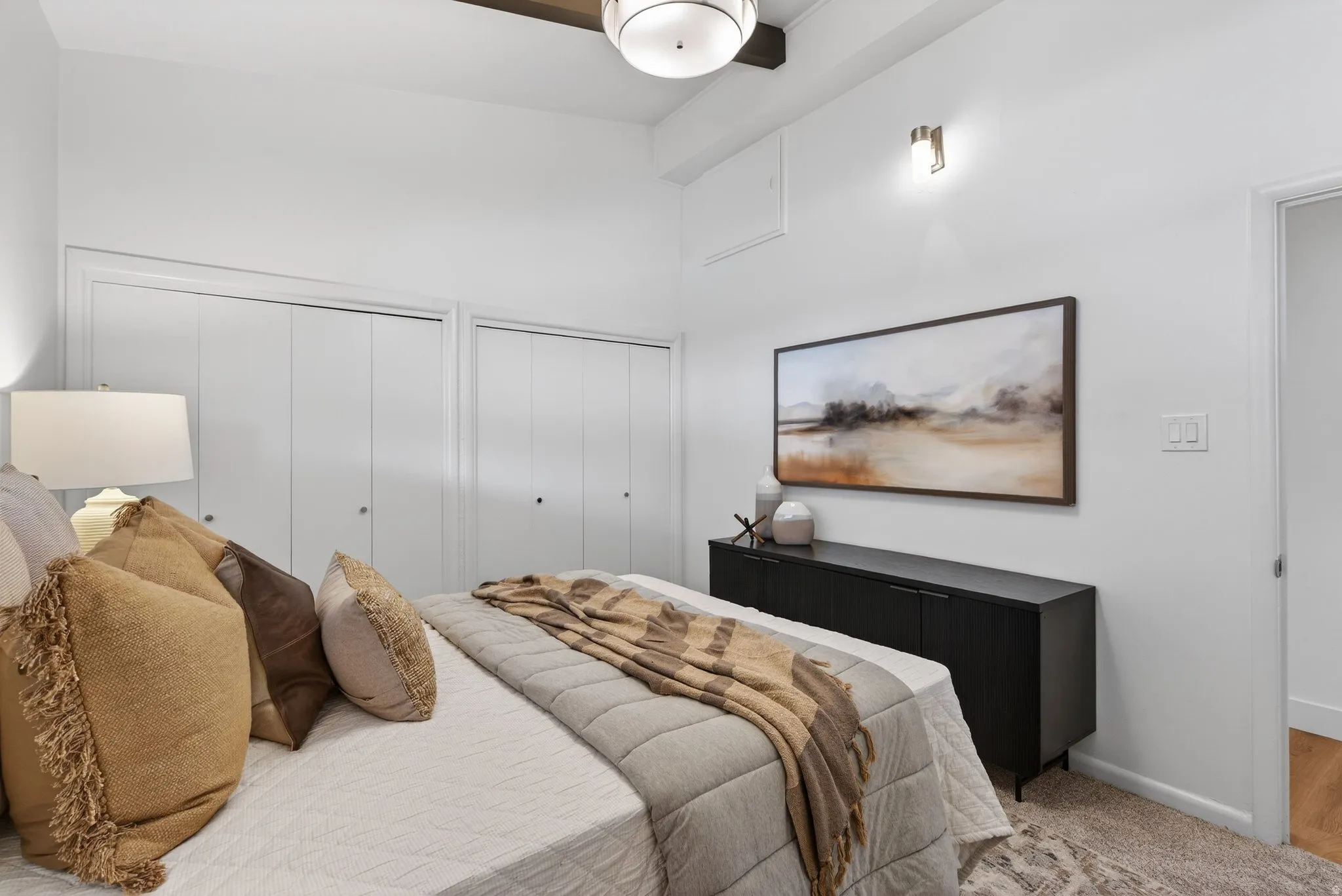 Primary Bedroom featuring twin closets for effortless organization and soft neutral tones throughout, this room is a perfectly space for rest and relaxation.