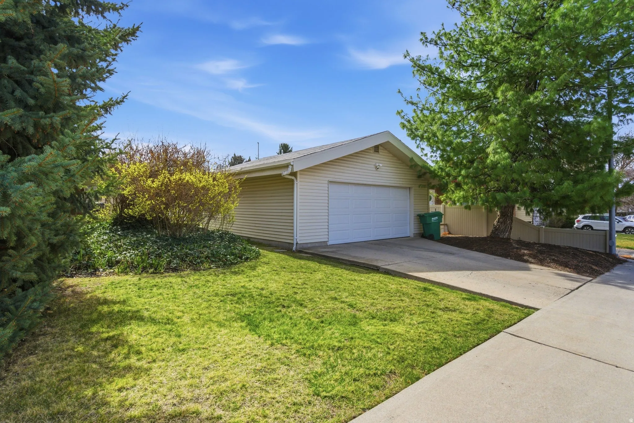 Spacious detached 2-car garage, offering a private and versatile space for vehicles, a workshop, or additional storage. Complemented by lush landscaping, this property offers unmatched utility and appeal.