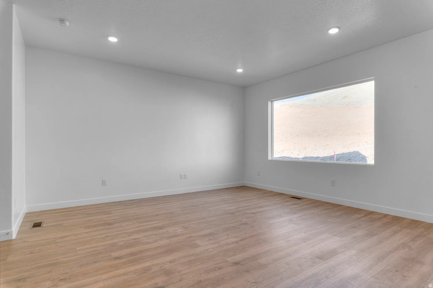 Spare room featuring light wood-style floors and recessed lighting