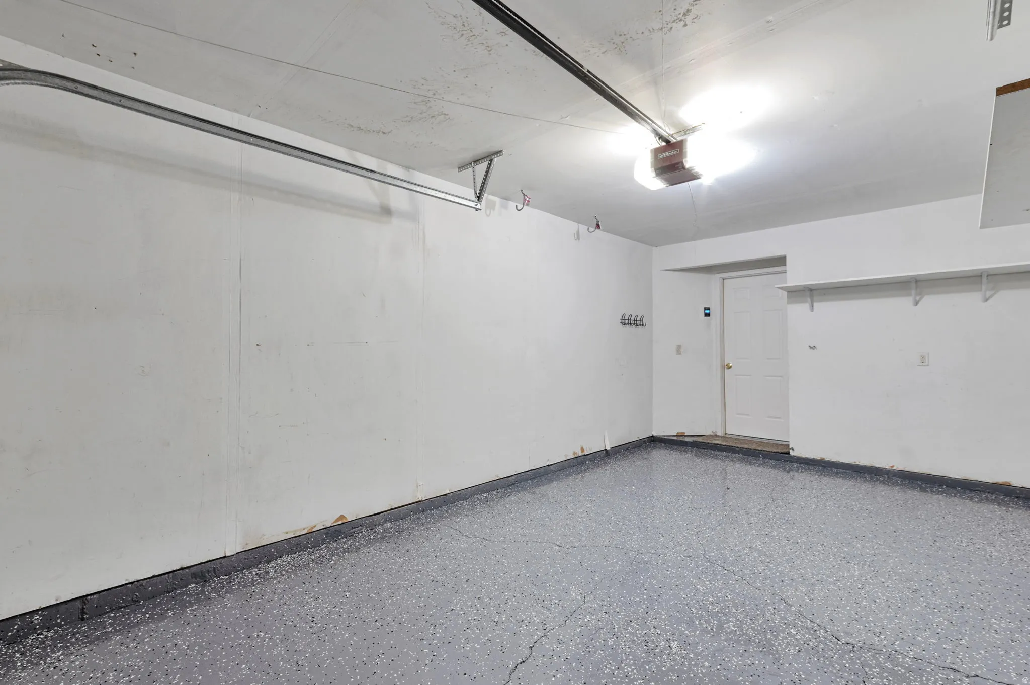 Garage featuring a garage door opener