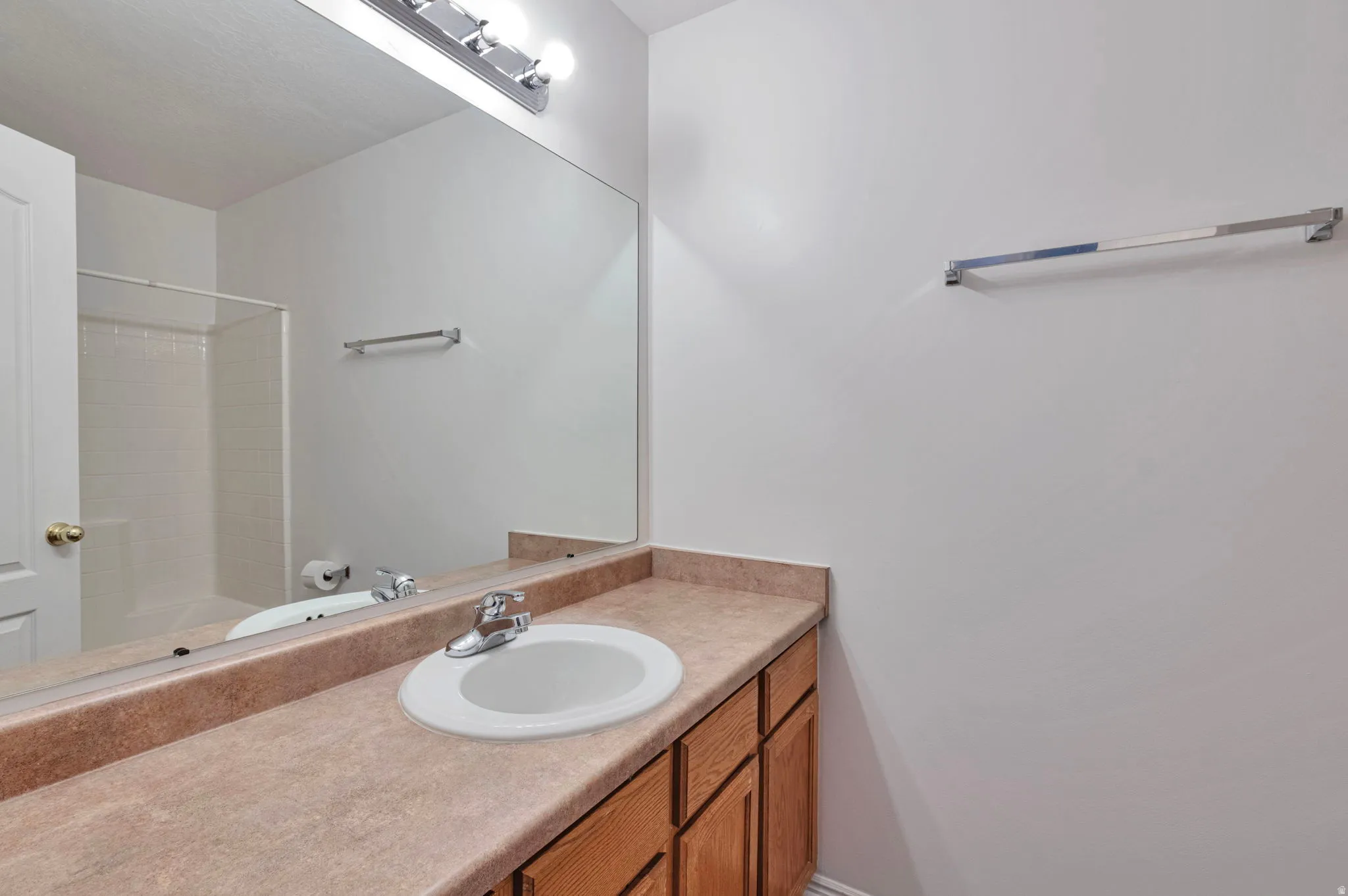 Full bath featuring vanity and a shower