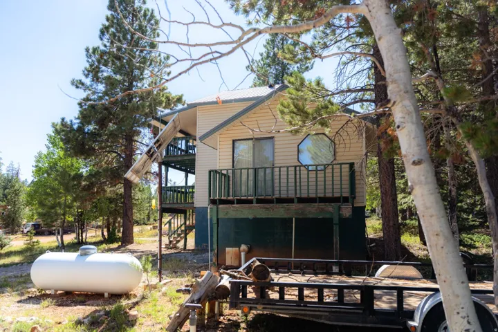 Back of house featuring a deck and stairway