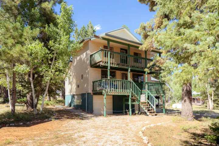 Back of property with a garage and driveway