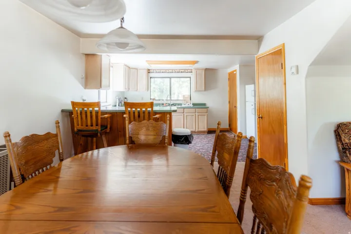 Dining area with light carpet and baseboards