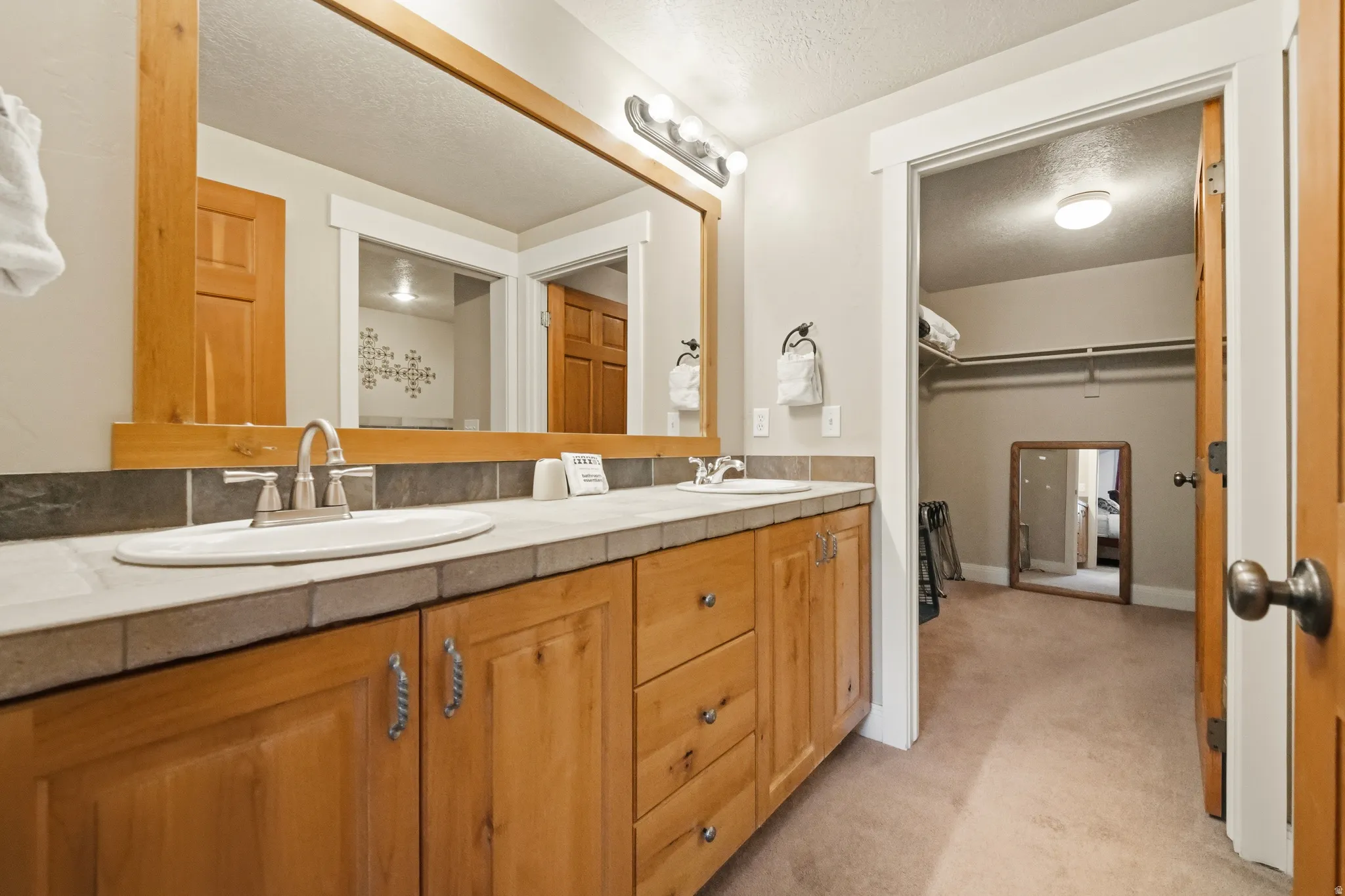 Bathroom with double vanity, and a spacious closet