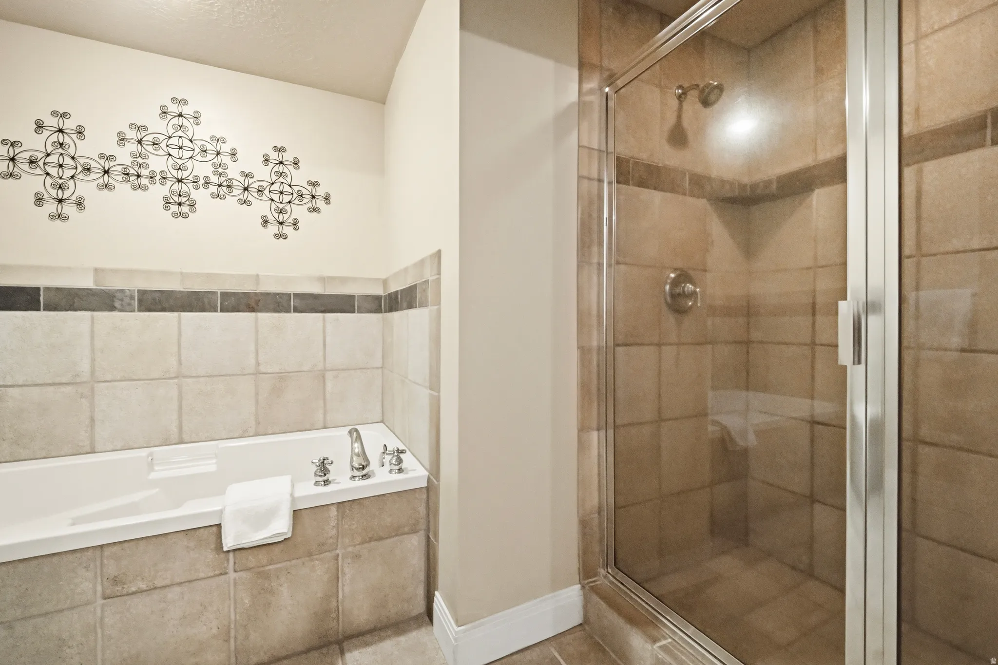 Full bathroom with a jetted tub, and separate shower