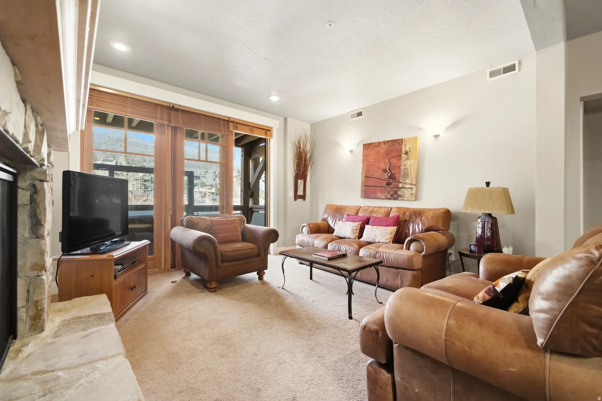 Hand-Selected Brown's Canyon Stone fireplace and recessed lighting