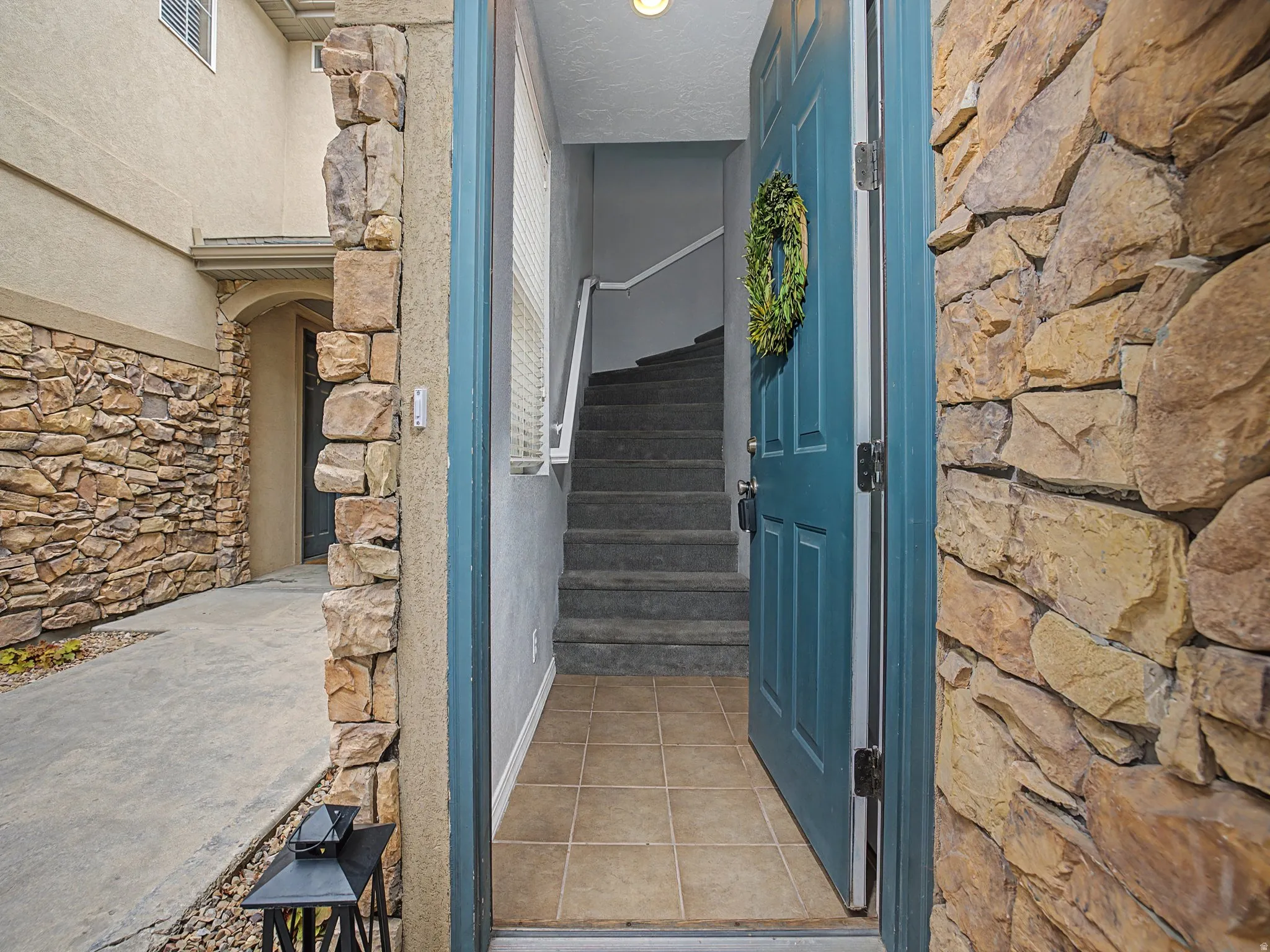 View of exterior entry featuring stone siding