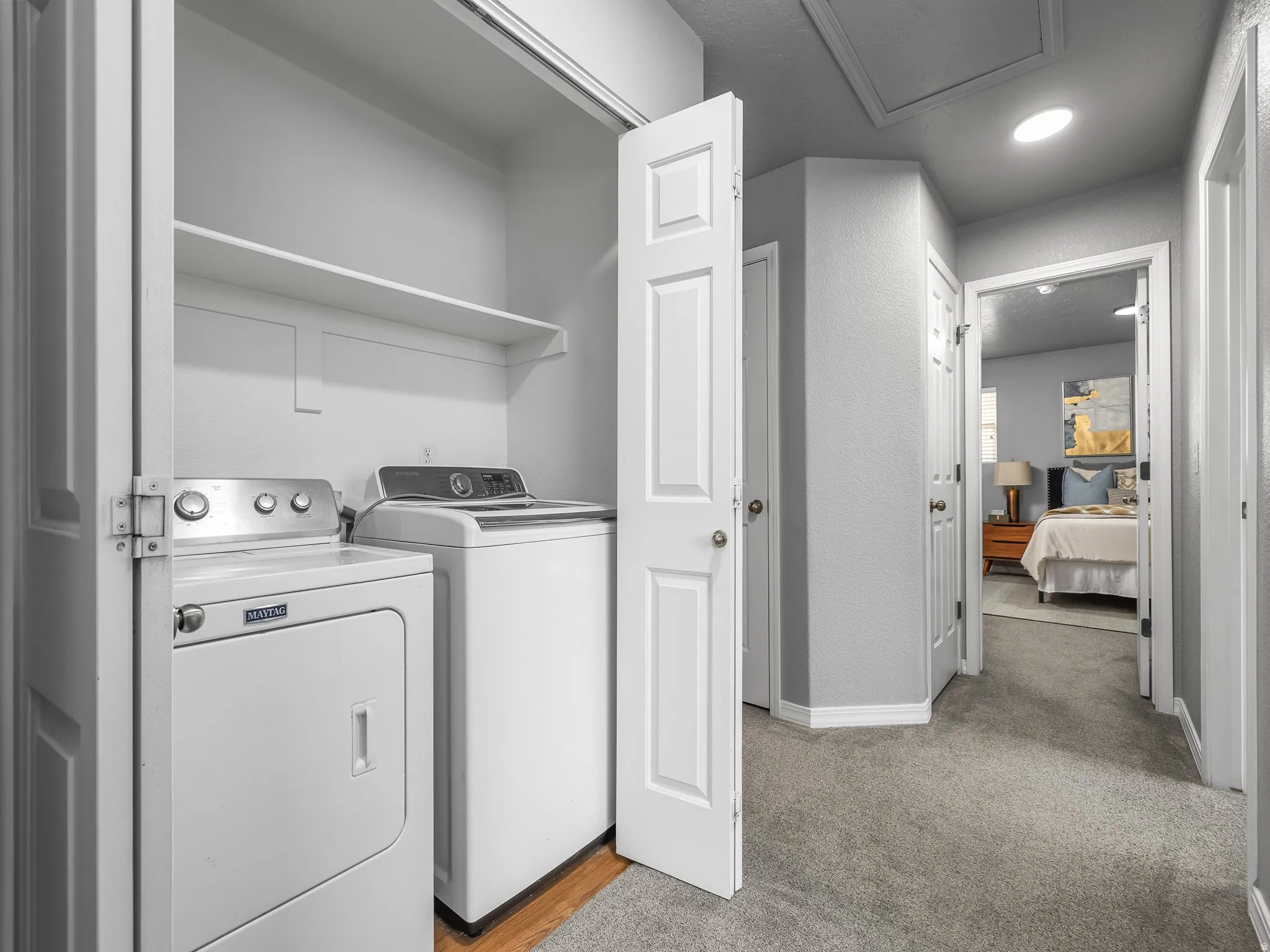 Laundry area featuring washer and dryer and light carpet