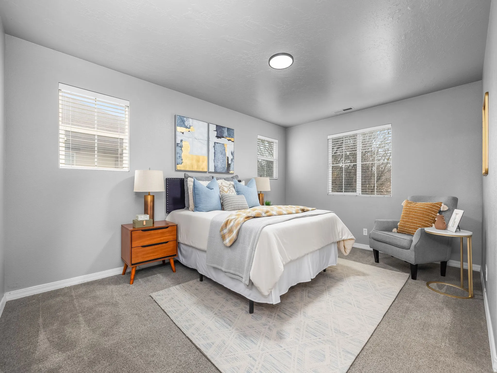Master bedroom with light carpet and a textured ceiling
