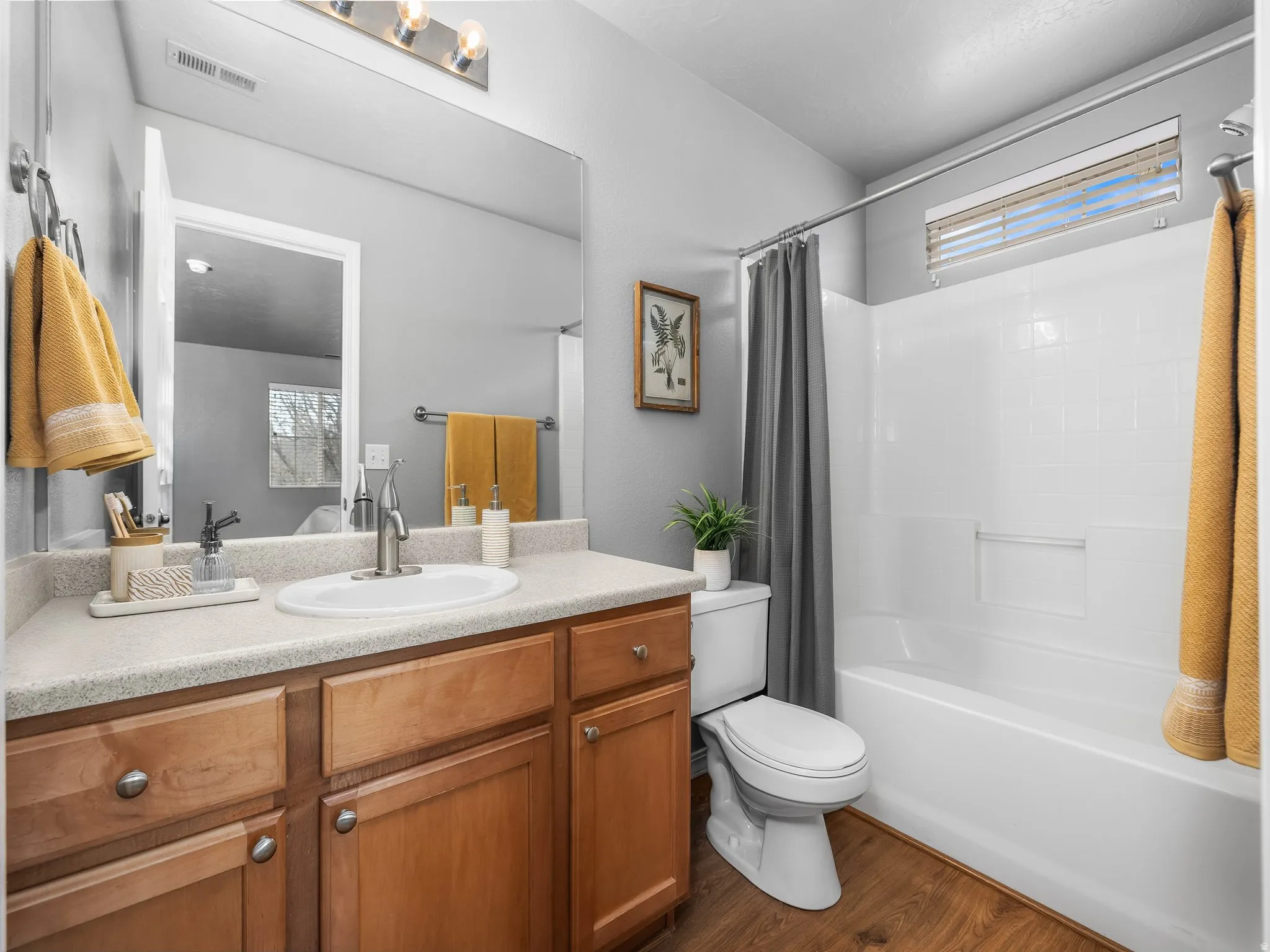 Master bathroom with vanity, shower / tub combo, and dark wood-style floors