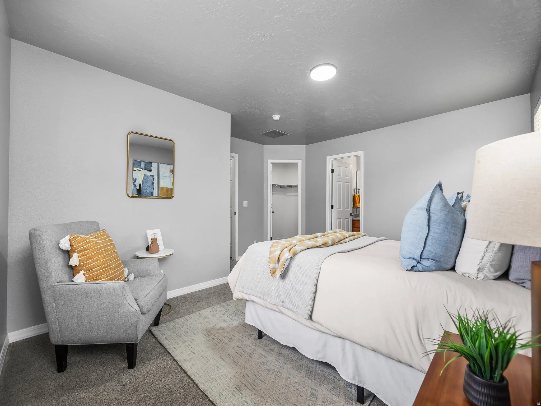 Master bedroom featuring carpet floors and a walk in closet