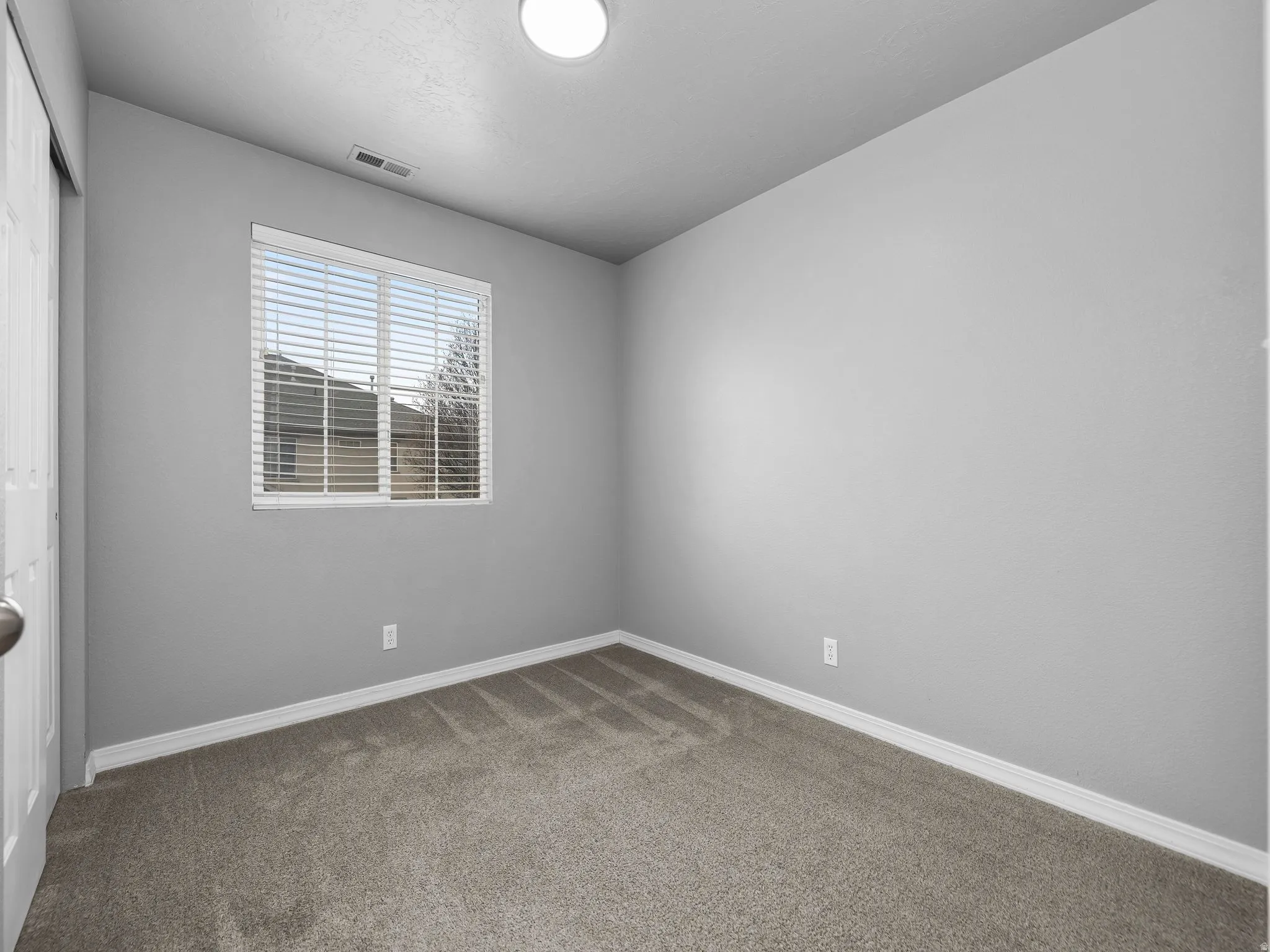 Unfurnished room with carpet and baseboards