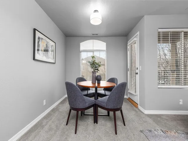 Dining space featuring carpet and baseboards